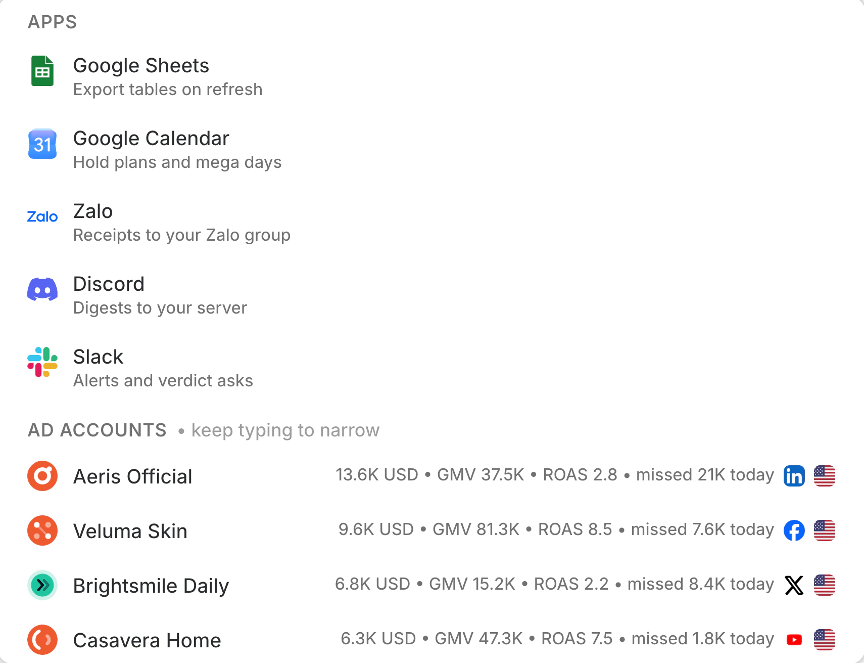 The console composer with @ typed: the apps Google Sheets, Google Calendar, Zalo, Discord and Slack, then ad accounts with their network avatars and today's spend, GMV and ROAS